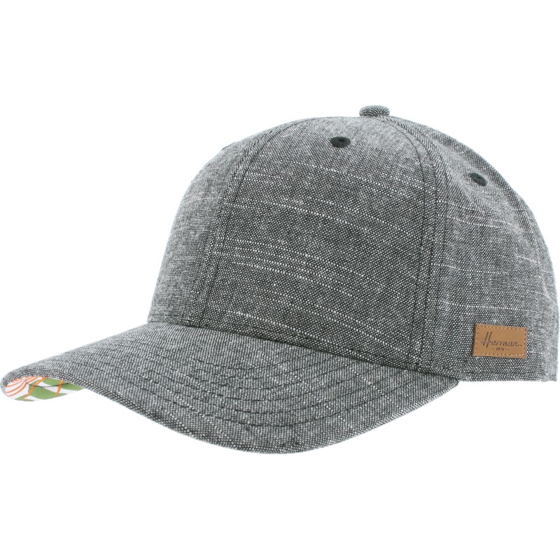 Plain color baseball cap with tropical pattern under the peak. Velcro